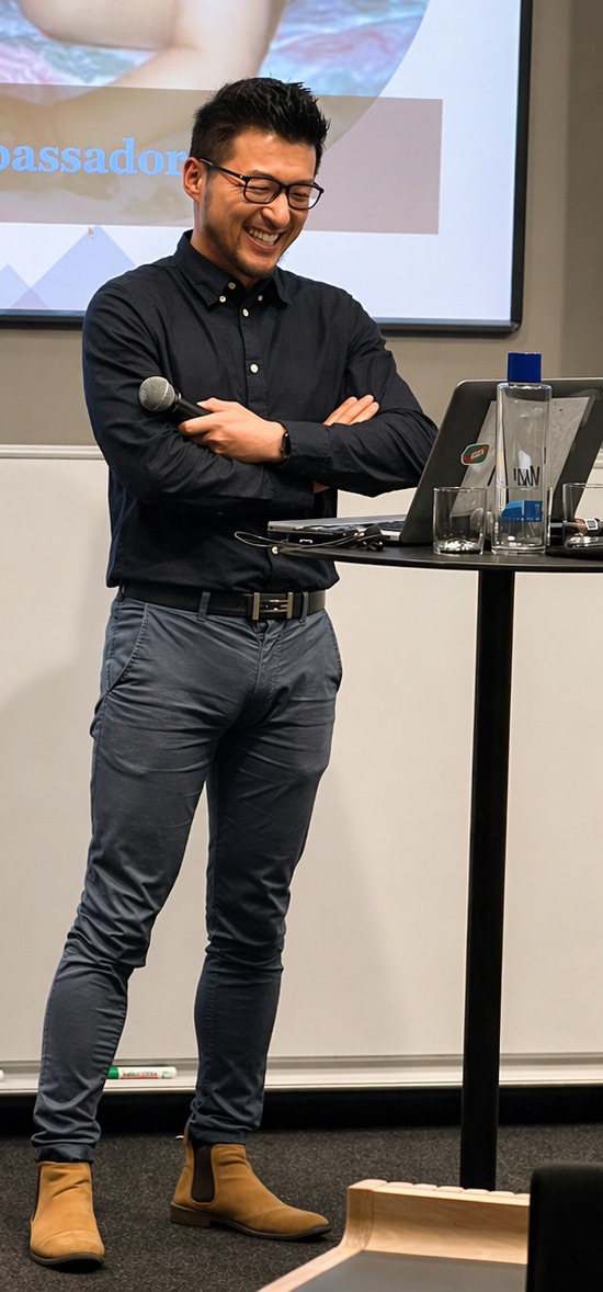 Muyi Yang speaking during a public presentation